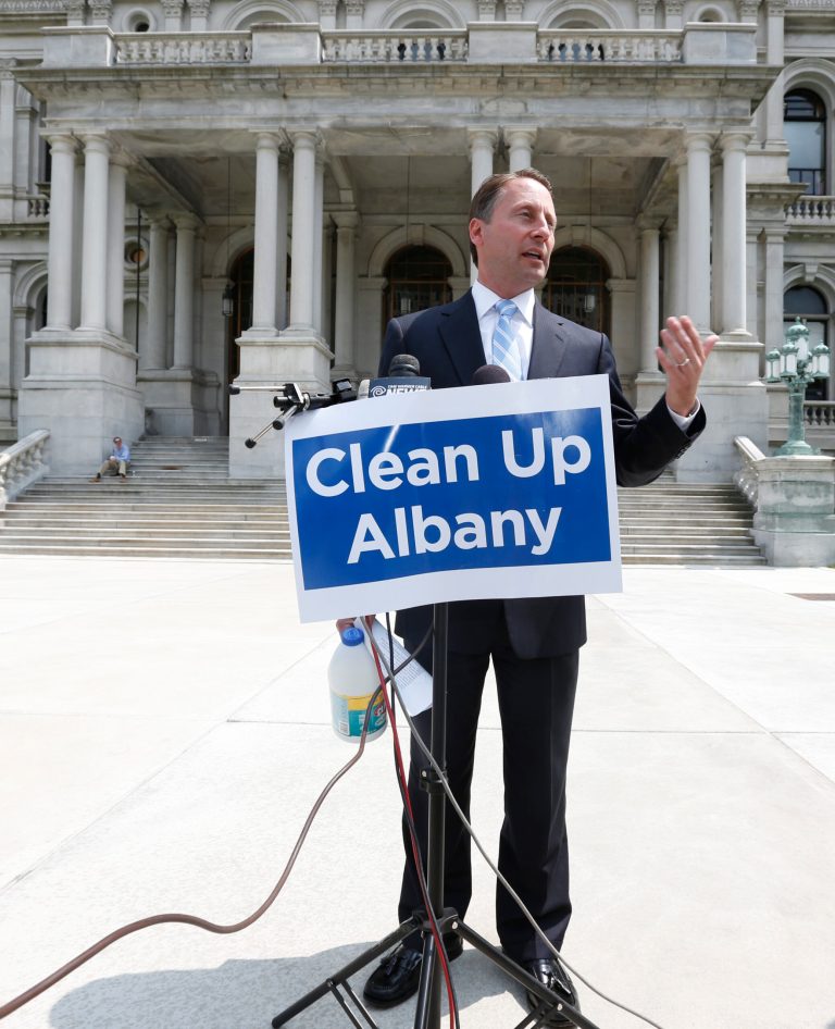 Republican gubernatorial candidate Rob Astorino, holding a jug of bleach, speaks about the need to clean up Albany during a news conference outside the Capitol on Tuesday, July 29, 2014, in Albany, N.Y. (AP Photo/Mike Groll)