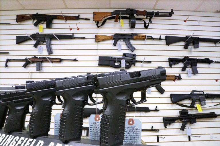 FILE - In this Jan. 16, 2013 file photo, assault weapons and handguns are seen for sale at Capitol City Arms Supply in Springfield, Ill. In a questionnaire for The Associated Press, the four GOP candidates for governor, state Sens. Bill Brady and Kirk Dillard, state Treasurer Dan Rutherford and businessman Bruce Rauner disagree on whether assault-style weapons should be banned. They also disagree on whether to support a measure creating minimum prison sentences for gun crimes. (AP Photo/Seth Perlman, File)