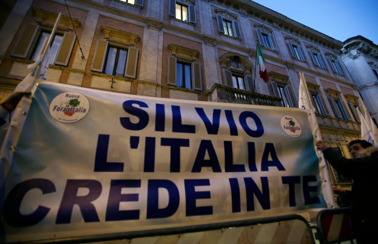  Supporters of former Italian premier Silvio Berlusconi expose a banner reading 