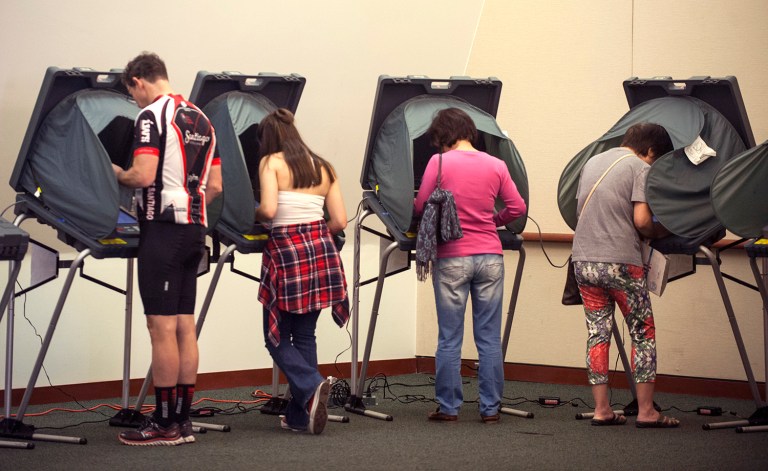 Voters cast their votes a day early at the City Hall in Irvine, Calif., Monday, Nov. 7, 2016. (Mindy Schauer/The Orange County Register via AP)