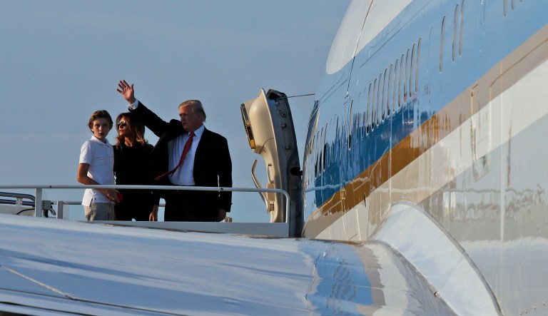 President Trump waves as he boards Air Force One with first lady Melania Trump, and Barron Trump, 11, at the Palm Beach International Airport, Sunday, Nov. 26, 2017, in West Palm Beach, Fla. Trump is returning to Washington after spending Thanksgiving at his Mar-a-Lago resort. (AP Photo/Alex Brandon)