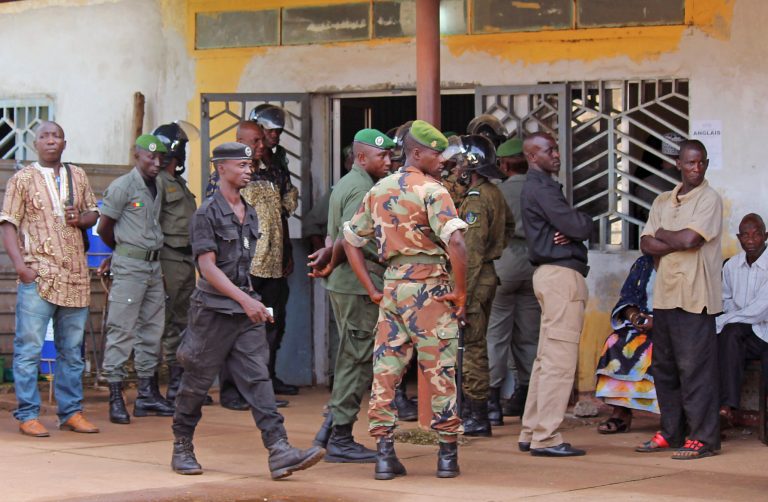 Guinea troops, center, provide security at the entrance to the morgue were the victims of a stampede that took place the night before at a rap concert are kept in the city of Conakry, Guinea, Wednesday, July 30, 2014. Hospital officials say at least 33 people are dead following a stampede at a rap concert in the capital of Guinea. Hundreds of people leaving a late-night rap concert on a beach in Guinea rushed to leave through a single exit, creating a stampede (AP Photo/Youssouf Bah)