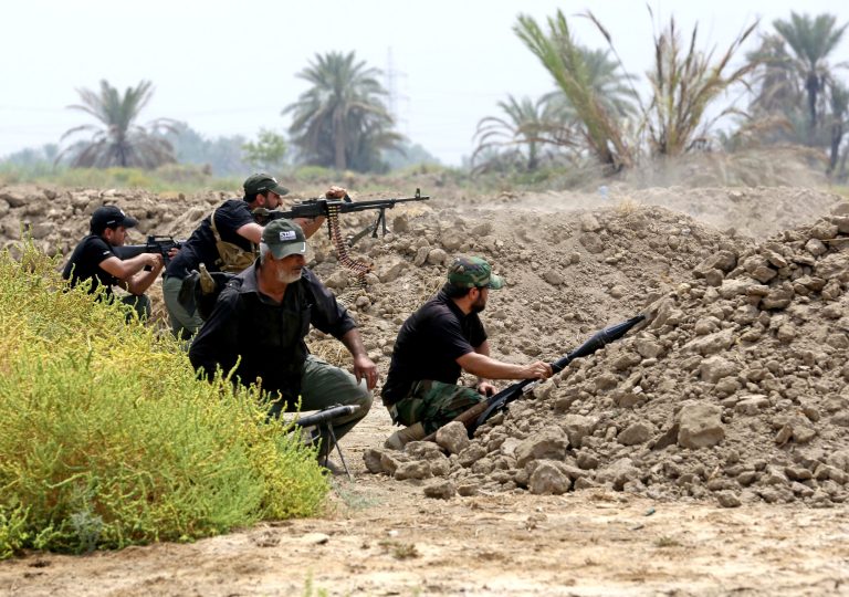 Iraq Shiite fighters prepare to fight militants from the extremist Islamic State group in Jurf al-Sakhar, 43 miles (70 kilometers) south of Baghdad, Iraq, Monday, Aug 18, 2014. Fighters of the voluntary armed group formed after the radical Shiite cleric Muqtatda al-Sadr called to protect holy shrines against possible attacks by Sunni militants. (AP Photo/Hadi Mizban)