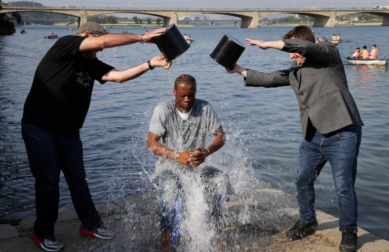 Two-time Grammy award winning rapper and a founding member of the Fugees, Pras Michel, gets doused by his friends for the ALS Ice Bucket Challenge, Sunday, Aug. 31, 2014 in Pyongyang, North Korea. The American rapper and documentary filmmaker said he wanted to join in the immensely popular charity challenge and thought of Pyongyang where the ice bucket craze is unknown, would be the perfect place to do it. (AP Photo/Wong Maye-E)