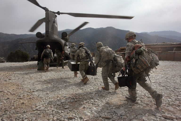 U.S. soldiers board an Army Chinook transport helicopter after it brought fresh soldiers and supplies to the Korengal Outpost on October 27, 2008 in the Korengal Valley, Afghanistan. (Photo by John Moore/Getty images)