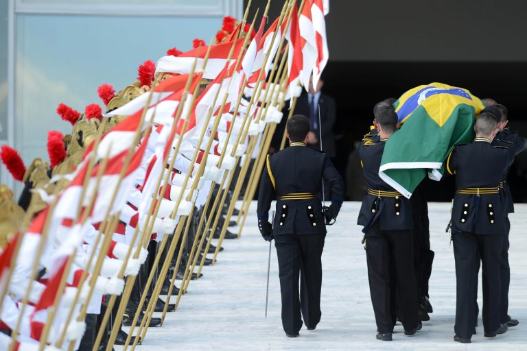   The coffin containing the remains of Brazilian architect Oscar Niemeyer is carried past an honor guard up a ramp leading to the Planalto presidential palace, in Brasilia, Brazil, Thursday, Dec. 6, 2012. Niemeyer, 104, the groundbreaking architect who designed Brazil's futuristic capital and much of the United Nations complex, died Wednesday night in Rio de Janeiro, the seaside city where he was born and where his remains will be buried after he is honored with a service in Brasilia at the presidential palace he designed. (Photo/Cadu Gomes)  