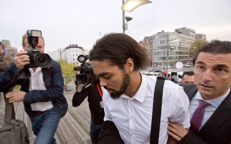 Co- defendant and key witness Jejoen Bontinck, center left, arrives with his lawyer Kris Luyckx to the main courthouse in Antwerp, Belgium on Monday, Sept. 29, 2014. Dozens of Belgians on Monday are going on trial accused of leading or being members of a terrorist organization that allegedly recruited fighters for jihadi groups in Syria. The case, one of the biggest-ever terror trials in Belgium, centers on the radical Muslim group Sharia4Belgium and its members. (AP Photo/Virginia Mayo)