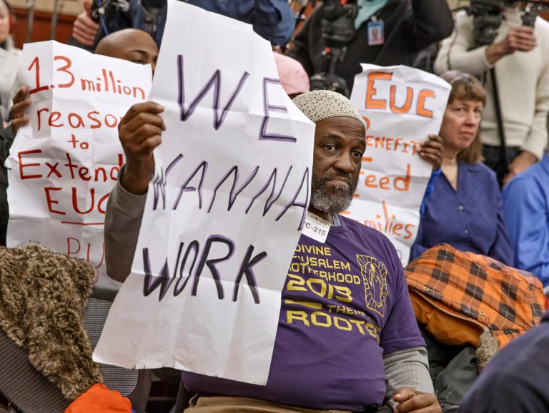 Audience members hold signs appealing for jobs as they attend a Democratic news conference about extendingÃÂ unemploymentÃÂ insurance benefits on Wednesday in Washington. (AP/J. Scott Applewhite)