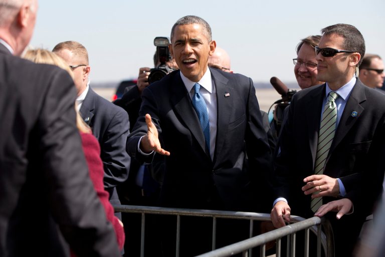 President Barack Obama greets people on the tarmac upon his arrival on Air Force One at Willow Run Airport in Ypsilanti, Mich., Wednesday, April 2, 2014, before traveling to the University of Michigan to speak about his proposal to raise the national minimum wage. (AP Photo/Carolyn Kaster)