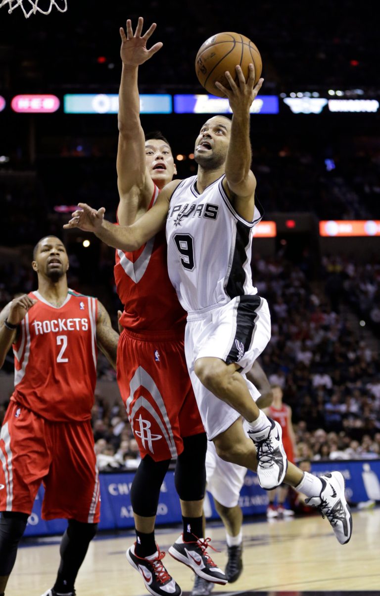   San Antonio Spurs' Tony Parker (9), of France, drives past Houston Rockets defenders Jeremy Lin, center, and Marcus Morris (2) during the second quarter of an NBA basketball game, Friday, Dec. 7, 2012, in San Antonio. (AP Photo/Eric Gay)  
