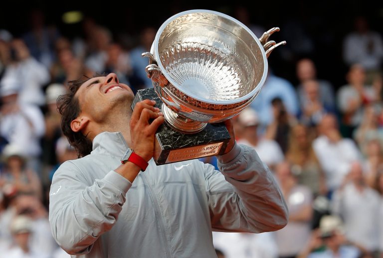 Spain's Rafael Nadal lifts up his cup after defeating Serbia's Novak Djokovic in their final match of  the French Open tennis tournament at the Roland Garros stadium, in Paris, France, Sunday, June 8, 2014. Nadal won 3-6, 7-5, 6-2, 6-4. (AP Photo/Michel Euler)