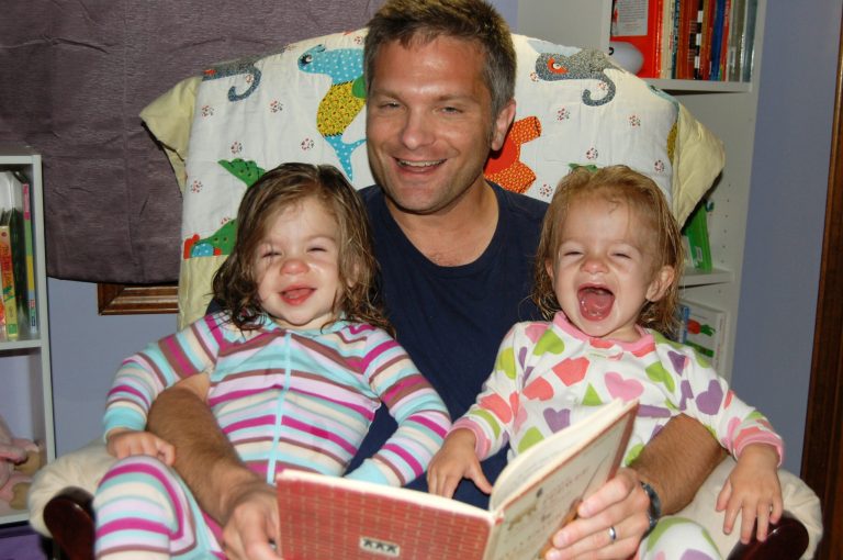 This Sept. 2, 2012 photo released by Sara Brandfon shows father Mike Brandfon holding his daughters  Abby, left, and Sophie in Chicago. The number of U.S. fathers home with their kids full time for a variety of reasons is down from a peak 2.2 million in 2010, the official end of the recession, to about 2 million in 2012, according to a report released Thursday, June 5, 2014, by the Pew Research Center. Brandfon, 48, of Chicago falls lost his job at a mid-size public relations company in December 2009 and was a stay at home dad. He joined a dads' group for park outings with the kids and the occasional night out for a beer. Once the girls were nearly 3 years old, he began looking for work again and landed a job last September.
