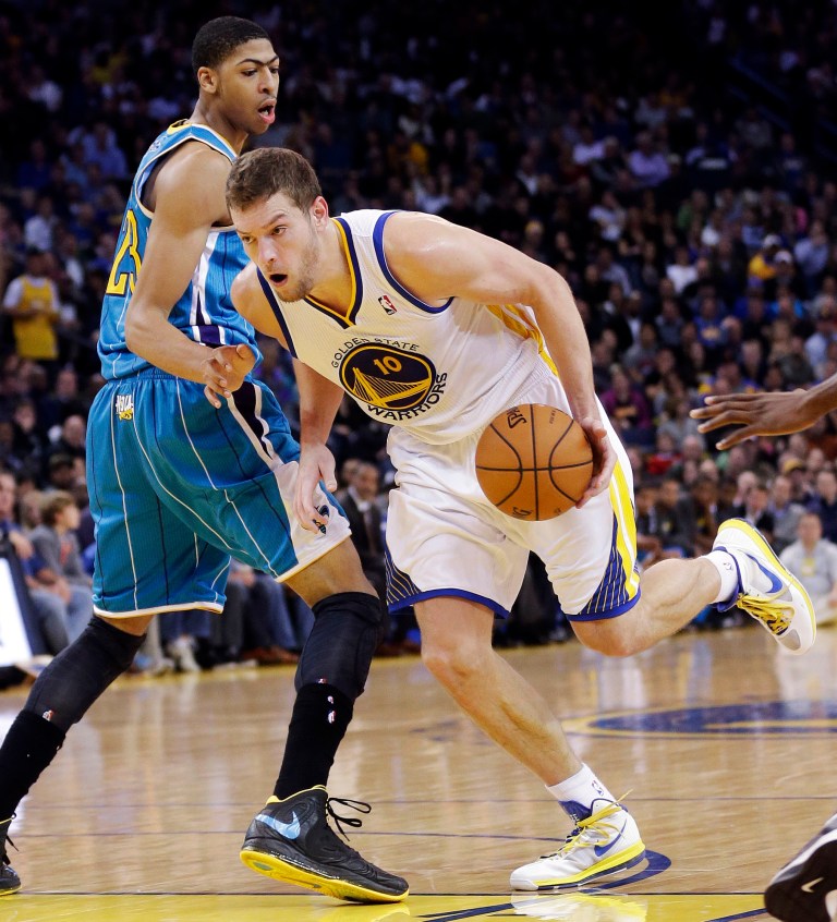   Golden State Warriors' David Lee (10) dribbles past New Orleans Hornets' Anthony Davis (23) during the first half of an NBA basketball game in Oakland, Calif., Tuesday, Dec. 18, 2012. (AP Photo/Marcio Jose Sanchez)  