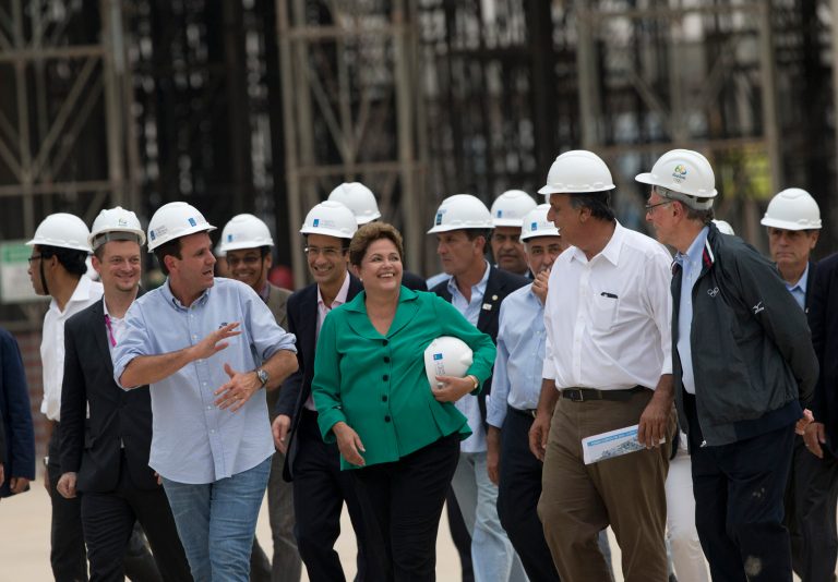 Rio Mayor Eduardo Paes, 3rd left with blue shirt, Brazil's President Dilma Rousseff, center, Rio Governor Luiz Fernando Pezao, 2nd right, and President of Rio 2016, Carlos Nuzman, right whith jacket, visit the works of the Rio 2016 Olympic Park in Rio de Janeiro, Brazil, Tuesday, Sept. 30, 2014. Chaired by Nawal El Moutawakel, the IOC Coordination Commission makes its seventh visit to Rio de Janeiro to monitor the preparation of the city for the 2016 Olympic and Paralympic Games. (AP Photo/Silvia Izquierdo)