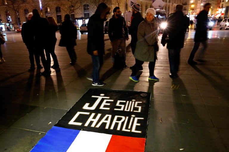 People walk around to banner reading 