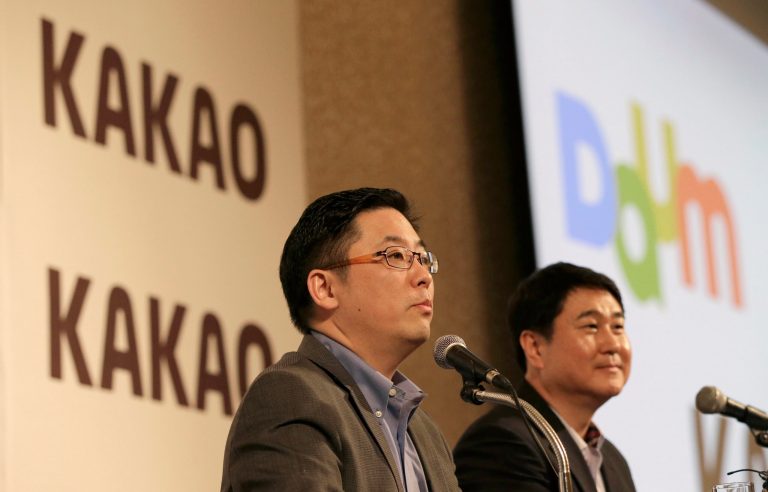 Daum Communications Corp. CEO Choi Sae-hoon, left, and Kakao Corp. CEO Sirgoo Lee listen to reporter's question during a press conference in Seoul, South Korea, Monday, May 26, 2014. Mobile messenger service Kakao Talk is seeking a backdoor listing on the South Korean stock exchange by combining with the country's second largest Internet portal. Daum Communications Corp. and Kakao Corp. said Monday that Kakao shareholders will get 1.556 Daum shares for each Kakao share they own. (AP Photo/Lee Jin-man)