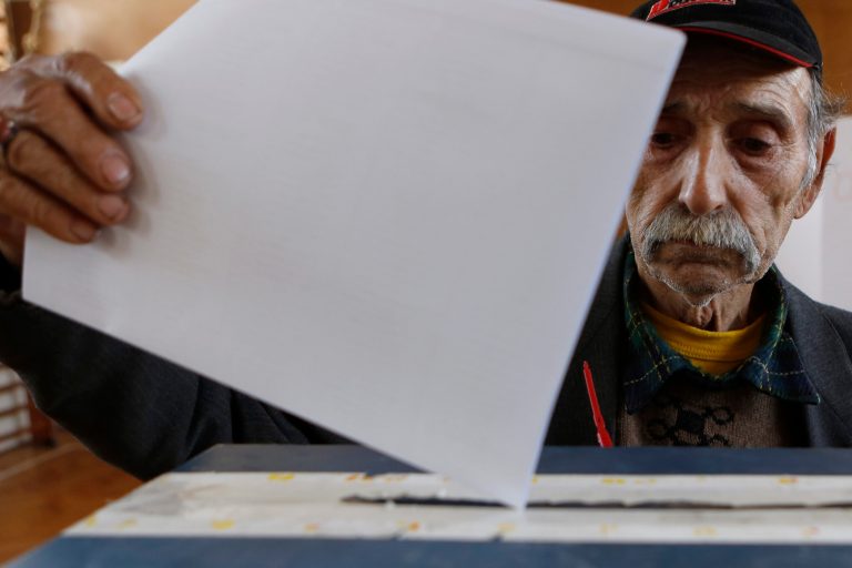 A Bosnian Roma man casts his ballots at a polling station near Tuzla, during election day in Bosnia, Sunday, Oct. 12, 2014. Bosnians are voting Sunday in general elections that will show whether people are more concerned about the 44 percent unemployment rate or still mired in wartime nationalist divisions. (AP Photo/Amel Emric)