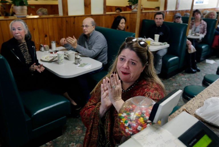 Susan English, foreground, a supporter of Democratic presidential candidate Hillary Clinton, applauds Clinton's televised concession speech, Wednesday, Nov. 9, 2016, at the Maugus Restaurant in Wellesley, Mass. (AP Photo/Steven Senne)