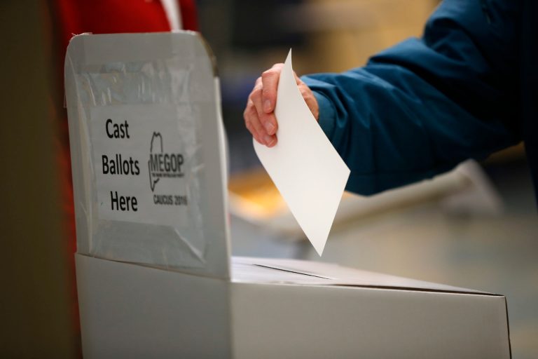 A voter casts her secret ballot at a Republican caucus Saturday, March 5, 2016, in Chelsea, Maine. (AP Photo/Robert F. Bukaty)
