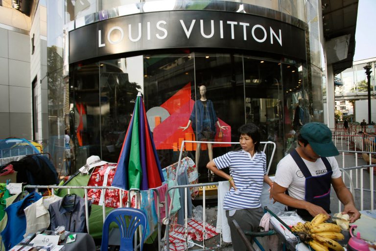 A luxury fashion shop is surrounded by anti-government protesters in central Bangkok, Thailand, Wednesday, Jan. 29, 2014. The latest spasm in Thailandâs ongoing political upheaval is taking an economic toll as anti-government protesters barricade Bangkok's major intersections and confrontations between protesters and government supporters periodically flare into deadly clashes. (AP Photo/Wally Santana)