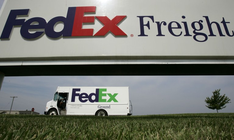 File - This June 21, 2005 file photo shows a Federal Express delivery truck leaving a FedEx distribution terminal in Edwardsville, Kan. FedEx Corp. is under criminal indictment and facing $1.6 billion in penalties for allegedly failing to police the activities of illegal online pharmacies that use the shipping service to deliver prescription drugs. (AP Photo/Charlie Riedel, File)
