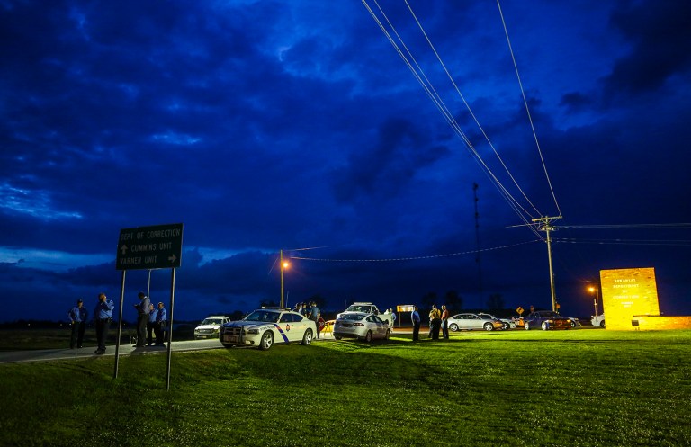 In this Monday evening, April 17, 2017 photo, the sun sets behind clouds over an Arkansas State Police command post outside the Varner Unit of the Arkansas Department of Correction near Varner, Ark. As state officials prepare to carry out a double execution Thursday ahead of a drug expiration deadline and despite the setback the U.S. Supreme Court delivered late Monday, lawyers for those condemned men look to be taking a different approach: claiming the prisoners are actually innocent. (Stephen B. Thornton/The Arkansas Democrat-Gazette via AP)
