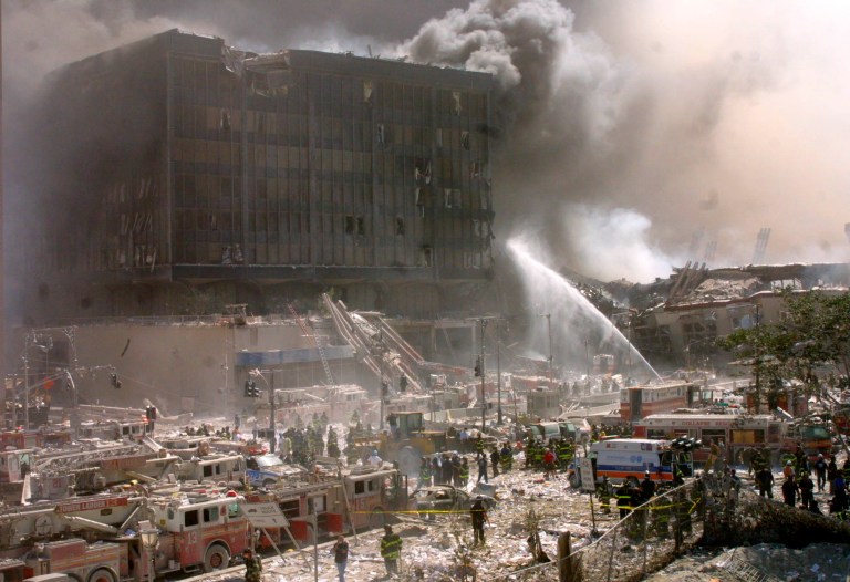 Firefighters fight a blaze amidst rubble after terrorists crashed two airliners into the World Trade Center in a deadly series of blows that brought down the twin 110-story towers in New York on Sept. 11, 2001. President Obama and Secretary of State John Kerry have both attributed terrorism to poverty and inequality. (AP Photo/Shawn Baldwin)