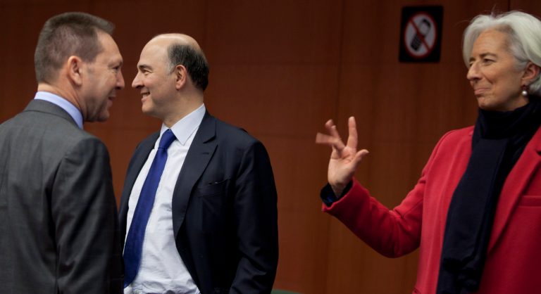Managing Director of the International Monetary Fund Christine Lagarde, right, waves to Greek Finance Minister Yannis Stournaras, left, and French Finance Minister Pierre Moscovici during a meeting of eurogroup finance ministers in Brussels on Monday, March 4, 2013. The eurogroup finance ministers are set to discuss details of a bailout for cash-strapped Cyprus, further steps of assistance for Portugal and Ireland as well as the controversial issue of direct banking recapitalizations through Europe's permanent rescue fund. (AP Photo/Virginia Mayo)