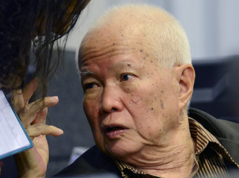 FILE - In this March 20, 2012 file photo released by the Extraordinary Chambers in the Courts of Cambodia, Khieu Samphan, a former head of state for the Khmer Rouge, gestures as testimony is given during his trial at the U.N.-backed war crimes tribunal in Phnom Penh. The slow course of justice for the leaders of Cambodia's murderous Khmer Rouge regime will inch forward again Wednesday, July 30, 2014 as the tribunal holds an initial hearing against a pair of defendants in their 80s facing genocide and other charges. Khmer Rouge head of state, Khieu Samphan, and Nuon Chea, right-hand man to the group's late chief, Pol Pot, are among the few surviving top leaders of the brutal communist group, which was responsible for an estimated 1.7 million deaths from starvation, exhaustion, disease and execution when it was in power in 1975-79. (AP Photo/Extraordinary Chambers in the Courts of Cambodia, Nhet Sok Heng, File)