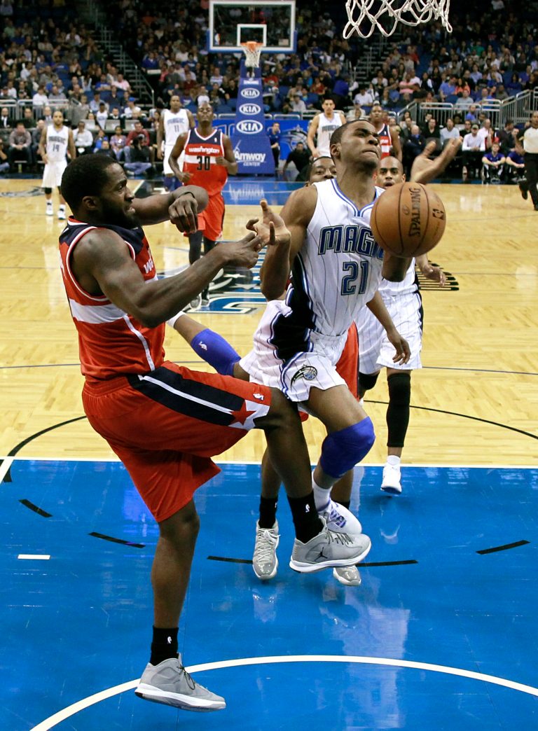   Orlando Magic's Moe Harkless (21) loses control of the ball after running into Washington Wizards' Martell Webster, left, on a drive to the basket during the first half of an NBA basketball game on Wednesday, Dec. 19, 2012, in Orlando, Fla. (AP Photo/John Raoux)  