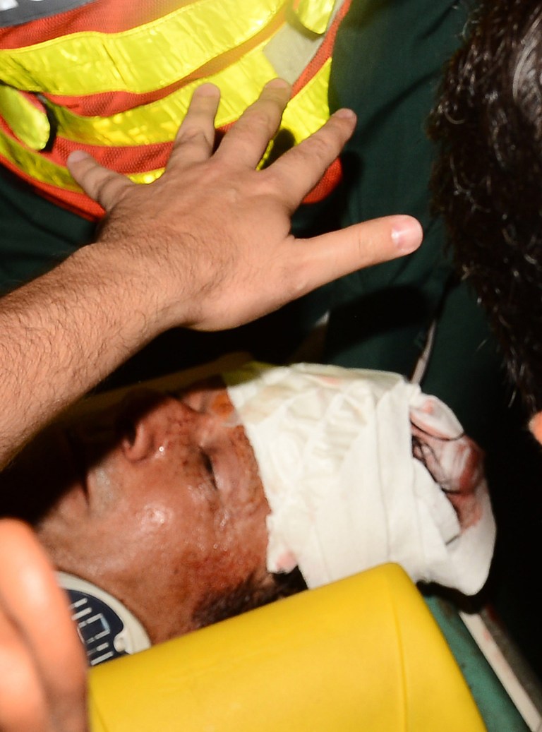 Rescue workers rush Imran Khan, Pakistan's cricket star-turned-politician to hospital in Lahore, Pakistan on Tuesday, May 7, 2013. One of Pakistan's most prominent politicians, former cricket star Imran Khan, fell from a stage at a political rally Tuesday, leaving him with two hairline skull fractures and uncertainty hanging over his ability to campaign ahead of Saturday's general election.(AP Photo/M.S. Shah)