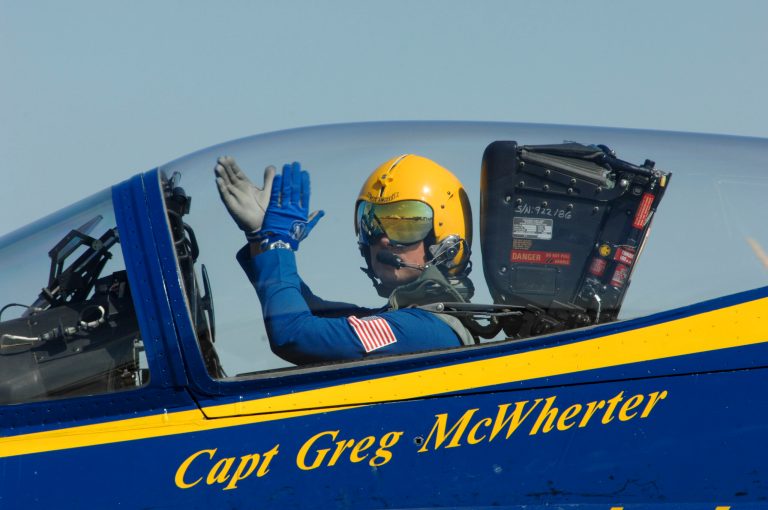 Capt. Greg McWherter, commanding officer and flight leader of the U.S. Navy flight demonstration squadron, the Blue Angels, responds to the crowd at the Guardians of Freedom Air Show in Lincoln, Neb. The U.S. Navy says McWherter has been relieved of duty over misconduct while he was commanding officer of the Blue Angels. McWherter allegedly allowed and in some cases encouraged sexually explicit humor, lewd speech and inappropriate comments among the famed precision flying team. McWherter's most recent post was as executive officer of Naval Base Coronado. (AP Photo/U.S. Navy, Jen Blake)