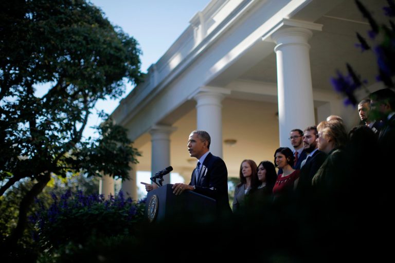 President Barack Obama, standing with supporters of his health care law, speaks in the Rose Garden of the White House in Washington, Monday, Oct. 21, 2013, on the initial rollout of the health care overhaul. Obama acknowledged that the widespread problems with his health care law's rollout are unacceptable, as the administration scrambles to fix the cascade of computer issues. (AP Photo/Charles Dharapak)