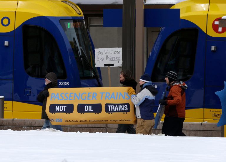 Climate change activists rallied outside the Union Depot in St. Paul, Minn., Wednesday, Feb. 26, 2014 prior to the visit of President Barack Obama. They urged Obama to reject the proposed Keystone XL oil pipeline from Canada to the Gulf Coast and say oil trains from North Dakota are disrupting Amtrak traffic. (AP Photo/Jim Mone)