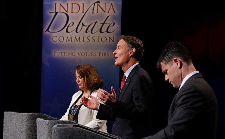 Candidates for Indiana's open Senate seat barely mentioned either Donald Trump or Hillary Clinton during their Tuesday night debate. (AP Photo/Michael Conroy, Pool)