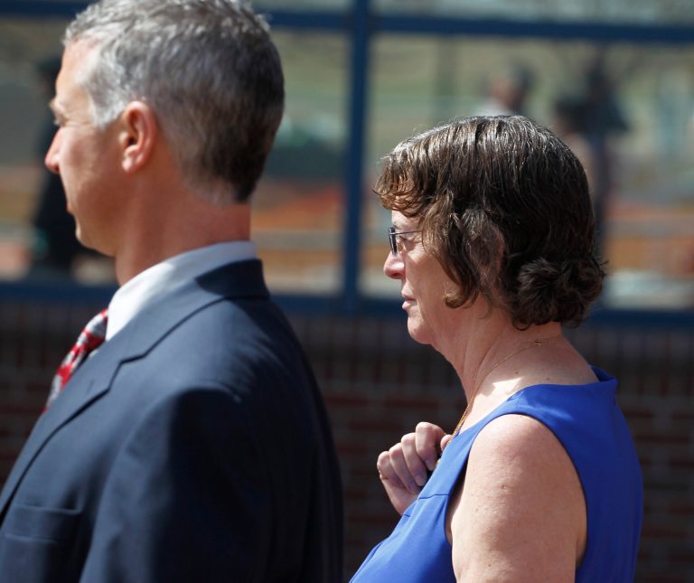 Arlene Holmes, right, the mother of James Holmes leaves the courthouse in Centennial, Colo., with a member of his defense team after a hearing where Aurora theater shooting suspect James Holmes asked to change his plea to not guilty by reason of insanity on Monday, May 13, 2013.(AP Photo/Brennan Linsley)