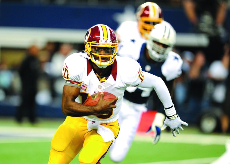 Matt Strasen/AP
Redskins quarterback Robert Griffin III threw for 311 yards and four touchdowns in Thursday's win over the Cowboys.