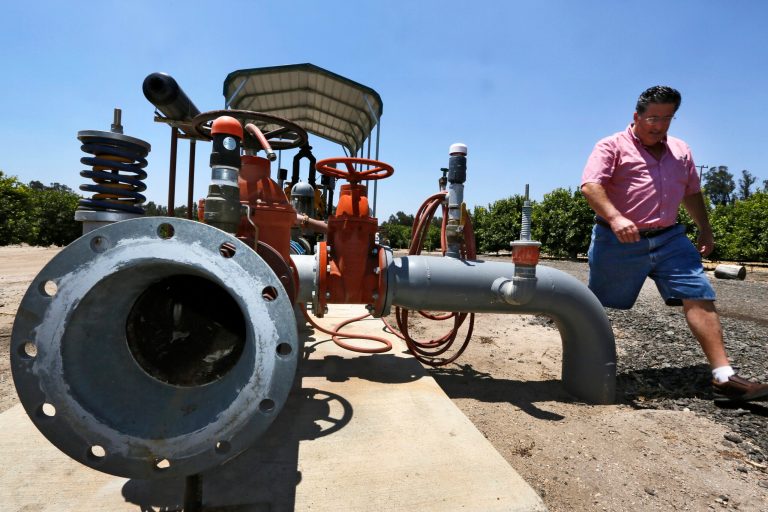 FILE - In this June 3, 2013 file photo, farmer David Schwabauer, a partner/manager of Leavens Ranches, a fourth-generation avocado and lemon grower, tours his property's irrigation system in Moorpark, Calif. For years Schwabauer has watched groundwater levels retreat with higher demand from encroaching development, forcing ranchers and farmers to sink piping deeper into the earth or drill expensive, new wells for irrigation. In the heat of summer, he pumps 3,000 gallons a minute for his thirsty trees. (AP Photo/Damian Dovarganes)