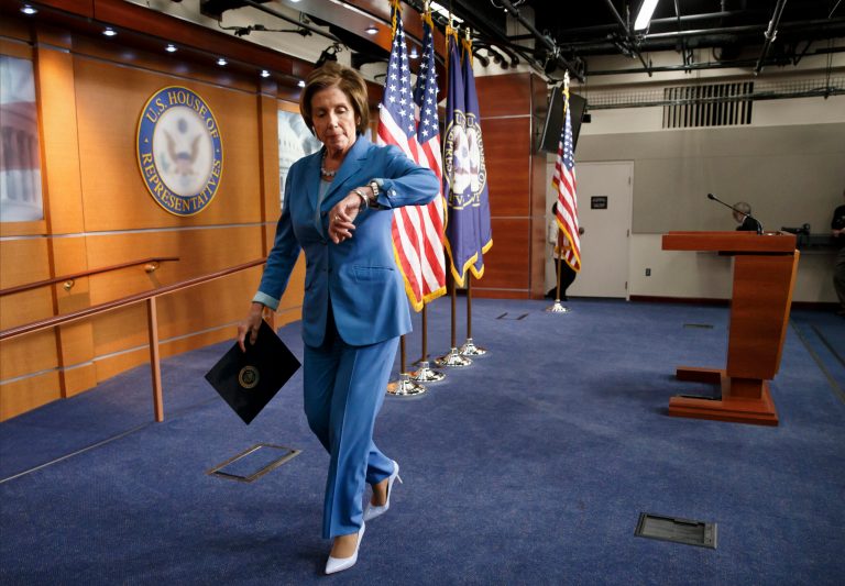On the last day before Congress takes a five-week summer recess, House Minority Leader Nancy Pelosi, D-Calif., checks her watch for a scheduled vote after speaking to reporters on Capitol Hill in Washington, Thursday, July 31, 2014. Yesterday, Republicans pushed through legislation to launch a campaign-season lawsuit against President Barack Obama, accusing him of deliberately exceeding the bounds of his constitutional authority, Democrats have branded the effort a political charade and an effort by top Republicans to mollify conservatives who want Obama to be impeached. (AP Photo/J. Scott Applewhite)