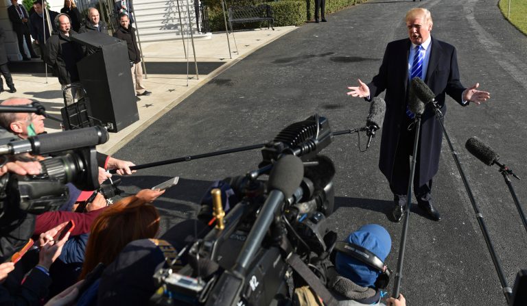 President Donald Trump talks with reporters as he departs from the South Lawn of the White House via Marine One in Washington, Saturday, Dec. 16, 2017, to spend the weekend at Camp David in Maryland. (AP Photo/Susan Walsh)