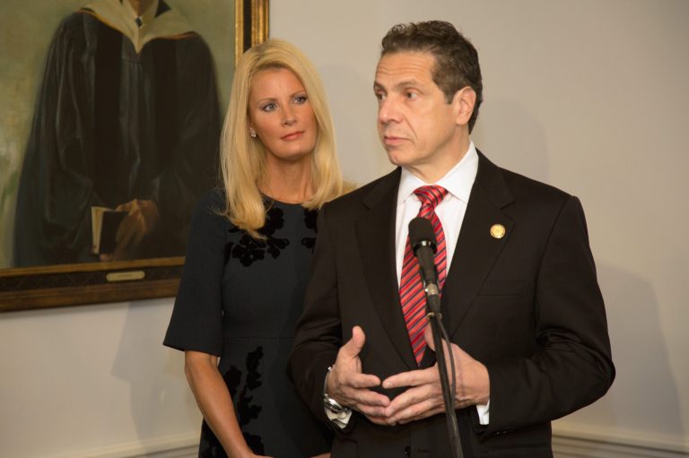 New York State Governor, Andrew Cuomo speaks while his girlfriend, television personality Sandra Lee, looks on during the 2014 general election at the Presbyterian Church of Mount Kisco on Nov. 4, 2014 in Mt Kisco, New York. (Photo by Kenneth Gabrielsen/Getty images)