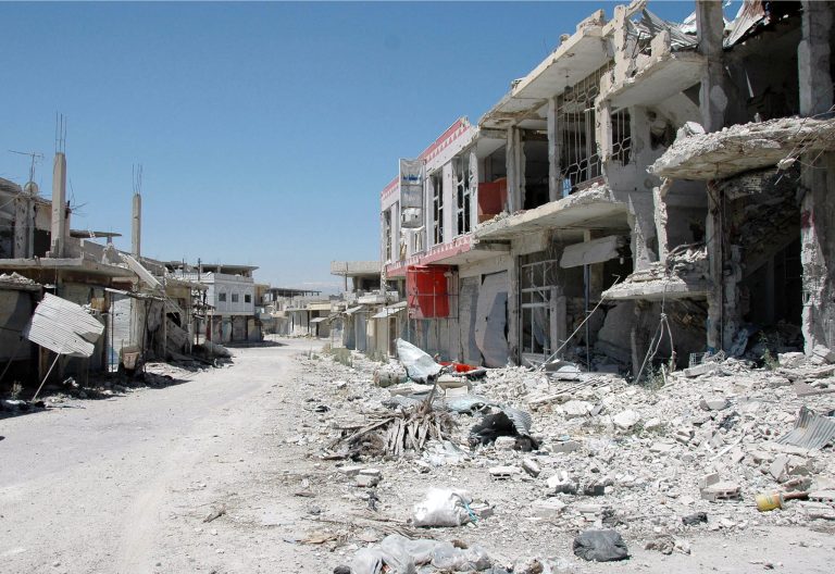 FILE -- In this June 5, 2013 file photo released, by the Syrian official news agency SANA, a damaged street is seen in Qusair, Syria. Syria's civil war has morphed into a proxy fight in which Shiite Iran has strongly backed Assad, while Sunni Arab nations have backed rebels. Many Sunni hard-liners around the Mideast have taken Hezbollah's intervention in Syria almost as a declaration of war by Shiites against Sunnis. (AP Photo/SANA, File)