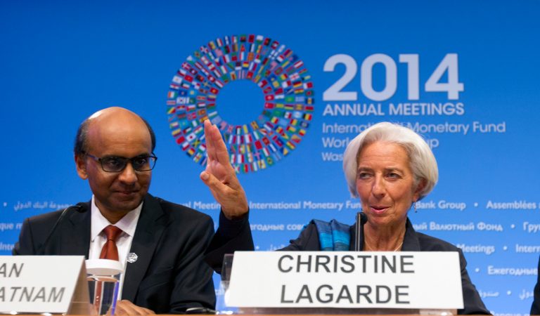 International Monetary Fund (IMF) Managing Director Christine Lagarde, accompanied by IMFC Chair and Singapore's Finance Minister Tharman Shanmugaratnam, speaks during a news conference at the World Bank Group-International Monetary Fund Annual Meetings at  IMF headquarters in Washington, Saturday, Oct. 11, 2014.  (AP Photo/Jose Luis Magana)