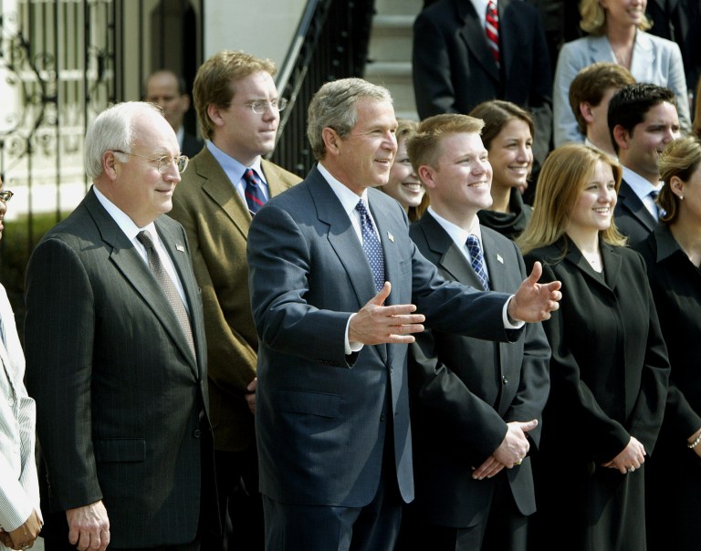 President Bush and Vice President Dick Cheney, left, pose for photos with White House interns at the White House, Wednesday, April 16, 2003. (AP Photo/Ron Edmonds)