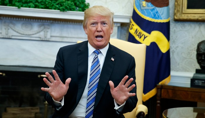 "We're not backing down," President Trump said when asked to respond to Paul Ryan's criticism of his decision. (AP Photo/Evan Vucci)