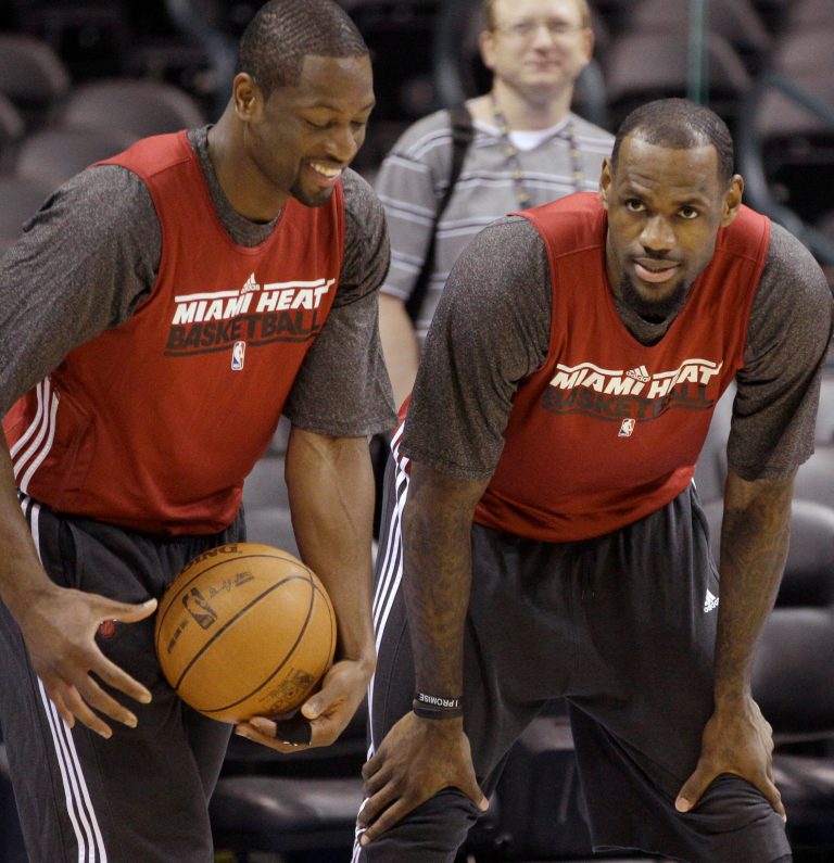   Miami Heat guard Dwyane Wade, left, and forward LeBron James talk during practice, Monday, June 11, 2012, in Oklahoma City. Game 1 of Â NBA basketball finals between the Heat and Oklahoma City Thunder is scheduled for Tuesday. (AP Photo/Sue Ogrocki)  