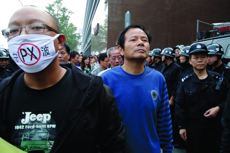 Protesters march towards the city government office in Zhejiang province's Ningbo city, protesting the proposed expansion of a petrochemical factory Sunday, Oct. 28, 2012. Thousands of people in the eastern Chinese city clashed with police Saturday while protesting the proposed expansion of the factory that they say would spew pollution and damage public health, townspeople said. (AP Photo/Ng Han Guan)