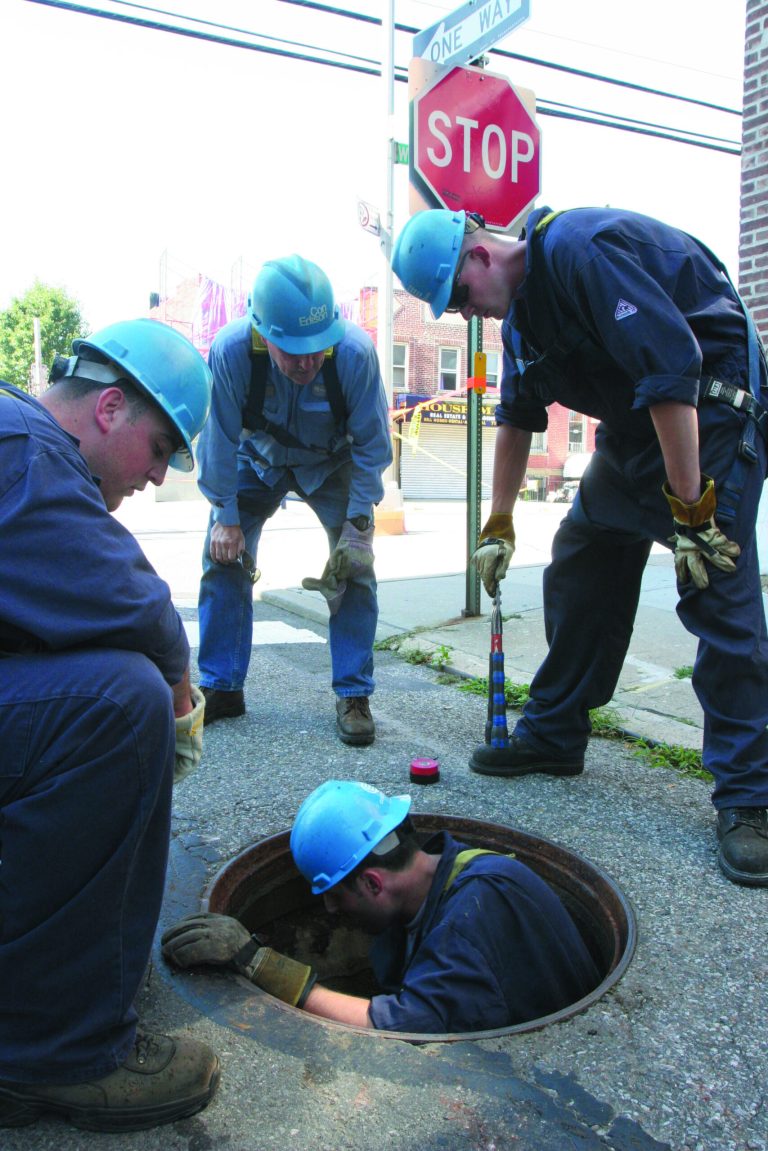 FILE- In this July 24, 2006 file photo, a Consolidated Edison crew checks a service box in the Queens borough of New York as they work to restore power during the eighth day of the blackout in the area. Consolidated Edison and its unionized workers are facing a midnight, July 1, 2012, deadline as their contract negotiations continue. (AP Photo/Tina Fineberg, File)