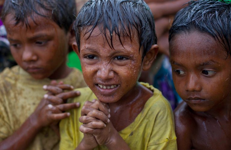 Internally displaced Rohingya boys shiver in rain in a makeshift camp for Rohingya people in Sittwe, northwestern Rakhine State, Myanmar, ahead of the arrival of Cyclone Mahasen, Tuesday, May 14, 2013. The U.N. said the cyclone, expected later this week, could swamp makeshift housing camps sheltering tens of thousands of Rohingya. Myanmar state television reported Monday that 5,158 people were relocated from low-lying camps in Rakhine state to safer shelters. But far more people are considered vulnerable. (AP Photo/Gemunu Amarasinghe)