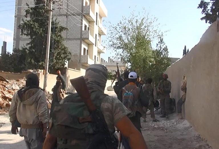 Children told Human Rights Watch they were beaten with hose and electric cable while in captivity in the Syrian town of Manbij, according to the Associated Press. Seen here, Islamic state group fighters in Kobani, Syria. (AP Photo/Raqqa Media Office)